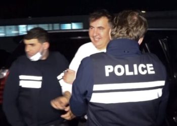 In this handout photo taken from video released by Georgian Interior Ministry Press Service, Georgian Police officers escort former President Mikheil Saakashvili after he was arrested in Rustavi, Georgia, Friday, Oct. 1, 2021. The prime minister of Georgia says former President Mikheil Saakashvili has been arrested. The announcement Friday by Prime Minister Irakli Garibashvili came about 18 hours after Saakashvili, who was convicted in absentia and has lived in Ukraine in recent years, posted on Facebook that he had returned to the country. (Georgian Interior Ministry Press Service via AP)