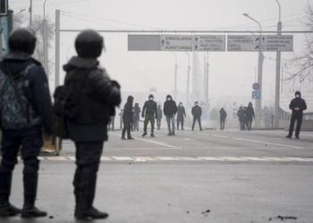 Demonstrators gather in front of police line during a protest in Almaty, Kazakhstan, Wednesday, Jan. 5, 2022. Demonstrators denouncing the doubling of prices for liquefied gas have clashed with police in Kazakhstan's largest city and held protests in about a dozen other cities in the country. (AP Photo/Vladimir Tretyakov)