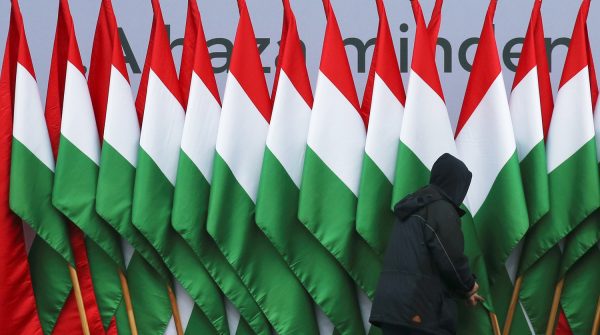 A man adjusts national flags before a pro-Orban rally during Hungary's National Day celebrations, which also commemorates the 1848 Hungarian Revolution against the Habsburg monarchy, in Budapest, Hungary, March 15, 2018. REUTERS/Marko Djurica     TPX IMAGES OF THE DAY - RC121D635BE0