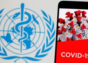 April 29, 2020, Ukraine: In this photo illustration the World Health Organization logo and a coronavirus image displayed on a mobile phone.. The number of the COVID-19 coronavirus confirmed cases in the United States exceeded one million and exceeded three million in the world, according of COVID-19 Dashboard by the Center for Systems Science and Engineering (CSSE) at Johns Hopkins University (JHU). The World Health Organization declared the coronavirus a global pandemic on 11 March 2020. (Credit Image: Global Look Press/Keystone Press Agency)