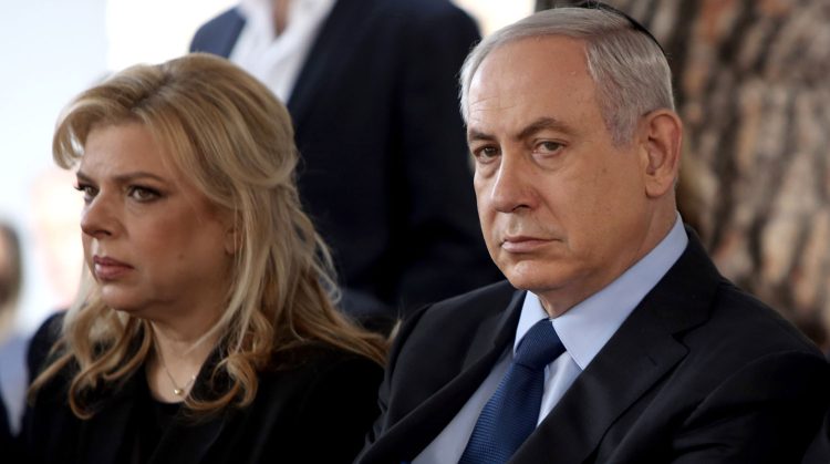 Israeli Prime Minister Benjamin Netanyahu sits with his wife Sara during the state funeral ceremony of the former President of the State of Israel Yitzhak Navon, on Sunday, Nov. 8, 2015, at the Mt. Herzl Cemetery in Jerusalem. Yitzhak Navon, who served as Israel's fifth president died Saturday at the age of 94. (Gali Tibbon/Pool Photo via AP)