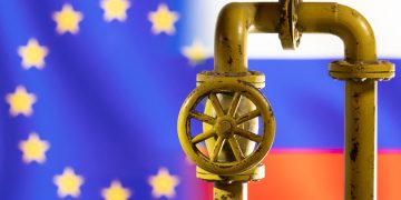 A model of the natural gas pipeline is seen in front of displayed word EU and Russia flag colours in this illustration taken March 8, 2022. REUTERS/Dado Ruvic/Illustration